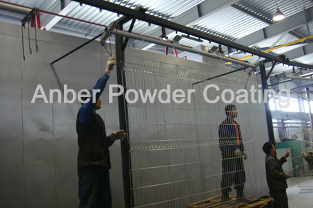 The workers are loading the mesh fence on hanger for test running